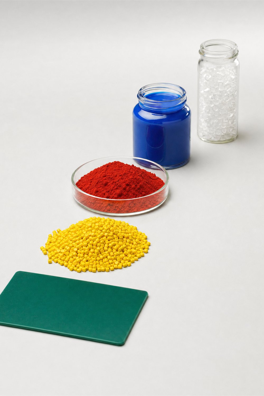 The four Delta lines: masterbatch pellets, powder pigment, liquid dispersion, additive and a plastic plaque